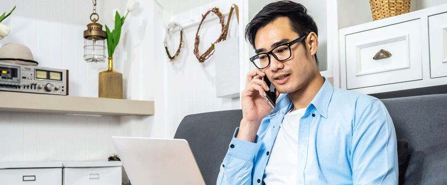 Guy on the Phone and Looking at Computer