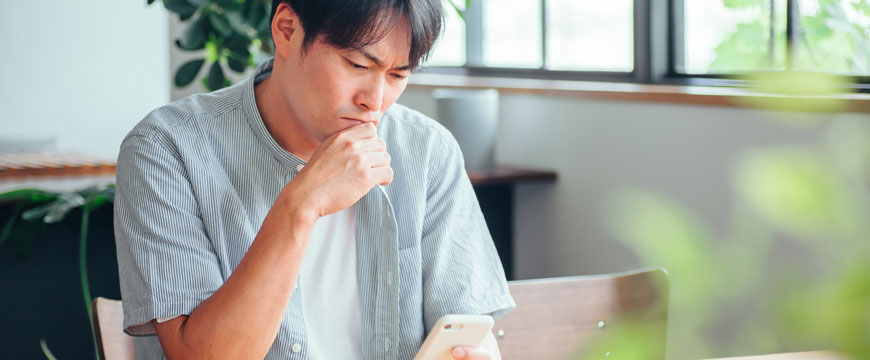 Guy Looking at Phone in Confusion 