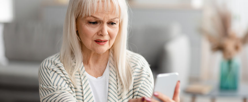 Woman Looking at her Phone in Confusion