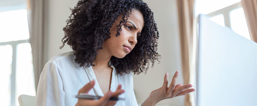 Girl Looking at Computer in Confusion 