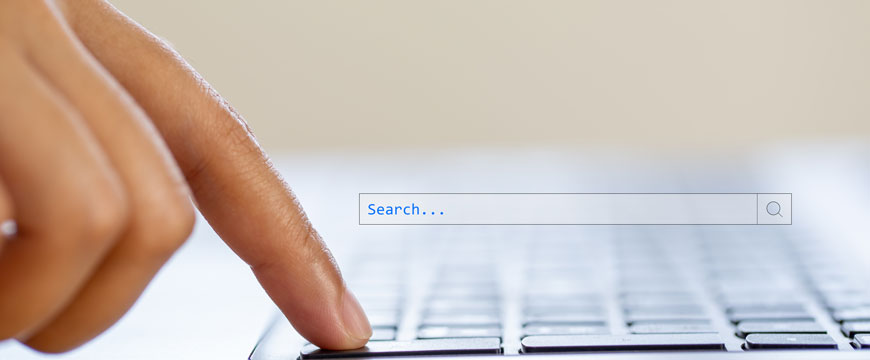 Finger on a Computer Displaying a Search Bar