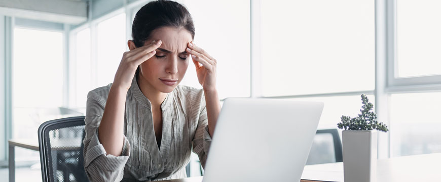 Girl on Computer with Hands on her Head