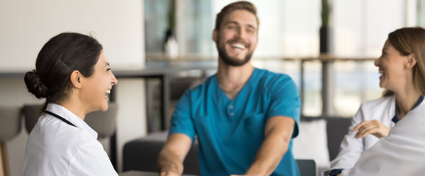 Healthcare Workers Laughing at a Table