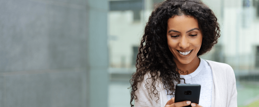 Woman using cell phone outside