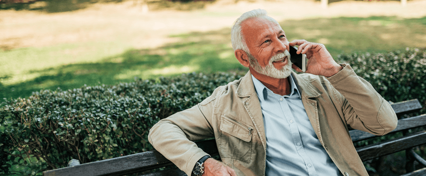 Man using phone on park bench